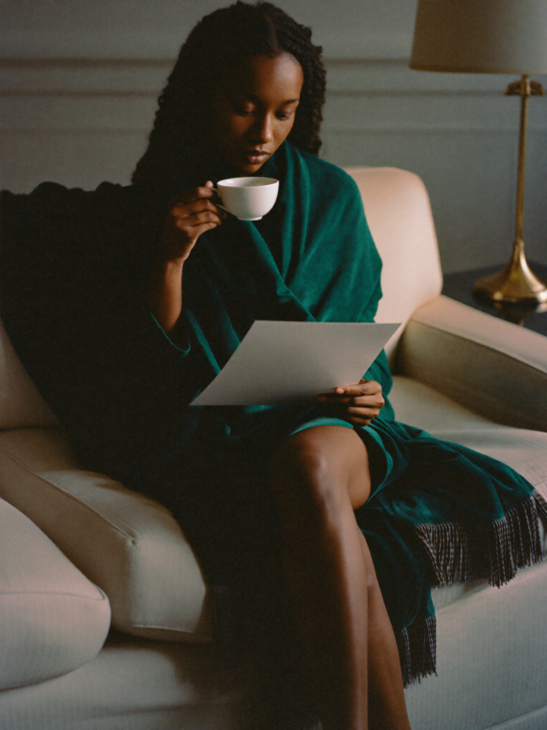 Reading a policy calmly over a cup of tea, taking a quiet moment.